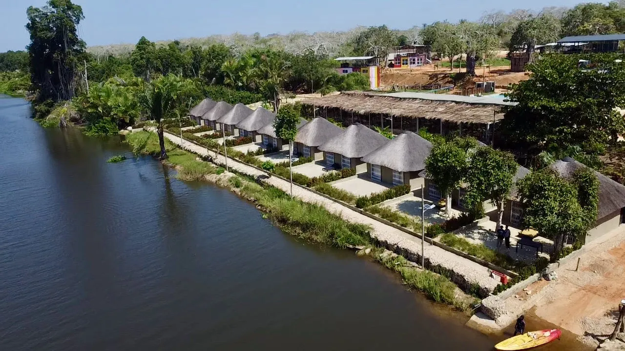 Aerial view of the riverside chalet row and canopy restaurant along the Kwanza River