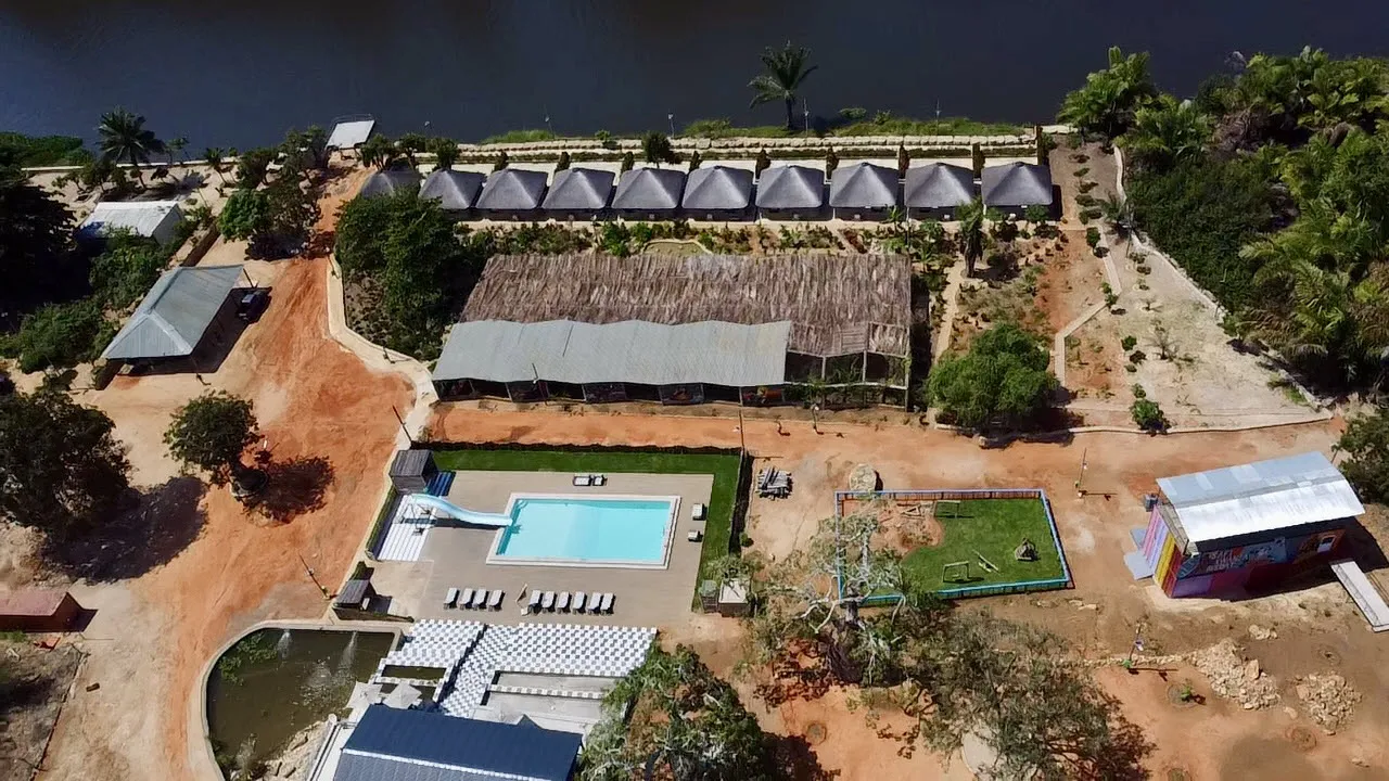 Aerial view of the resort's pool deck and forest surrounds from above