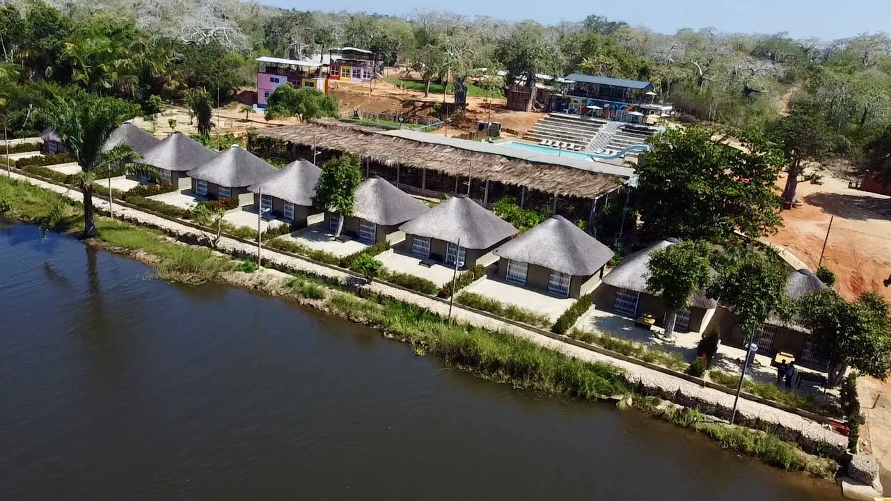Aerial view of the chalet row and canopy restaurant curving along the riverbank