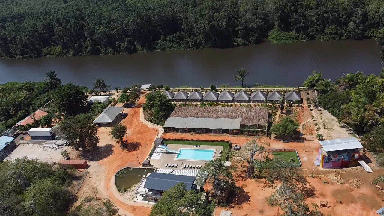 Aerial view of Safi Kwanza Resort showing the pool, gym, chalets and river