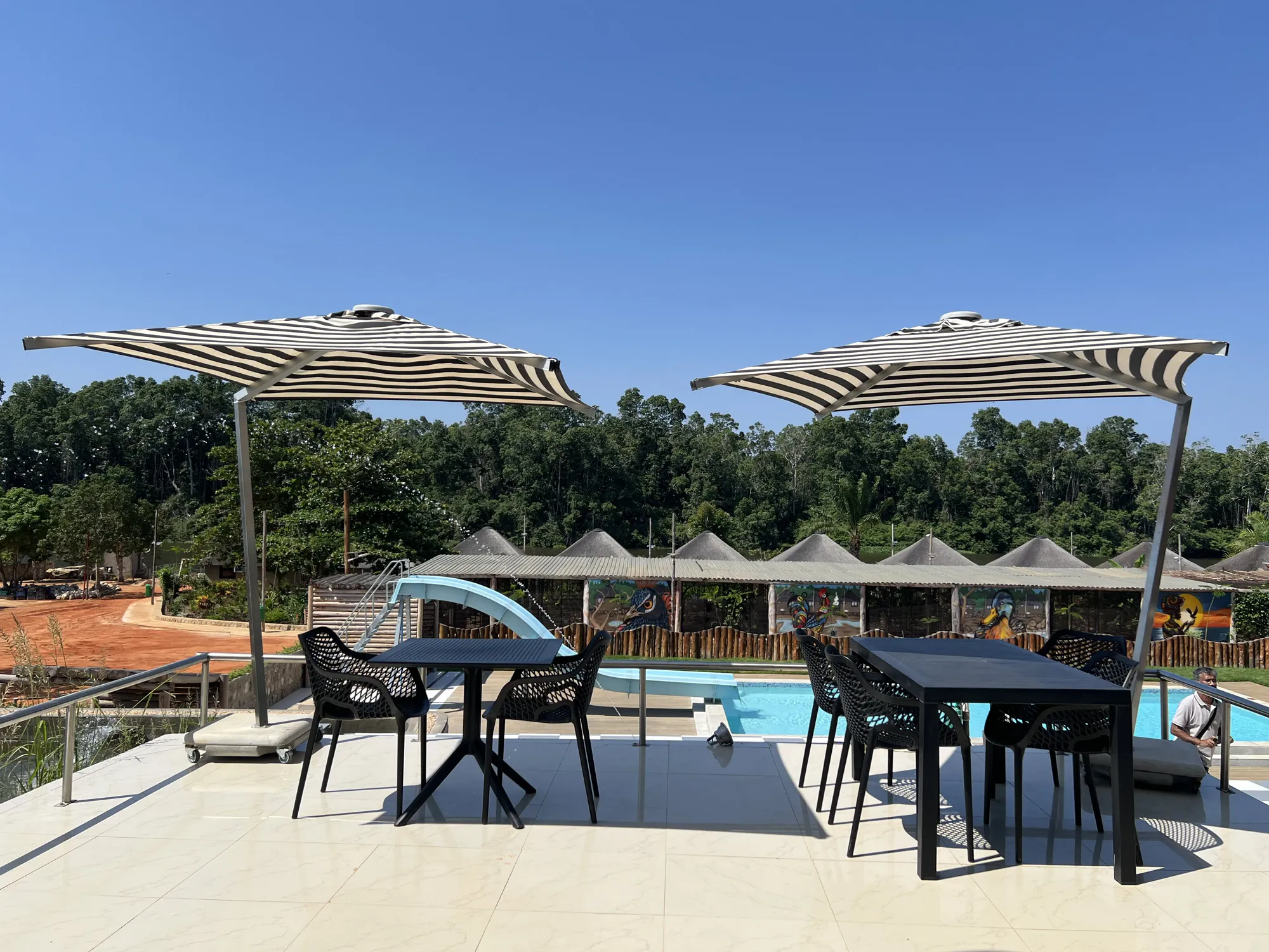 Rooftop dining terrace overlooking the pool and thatched chalets