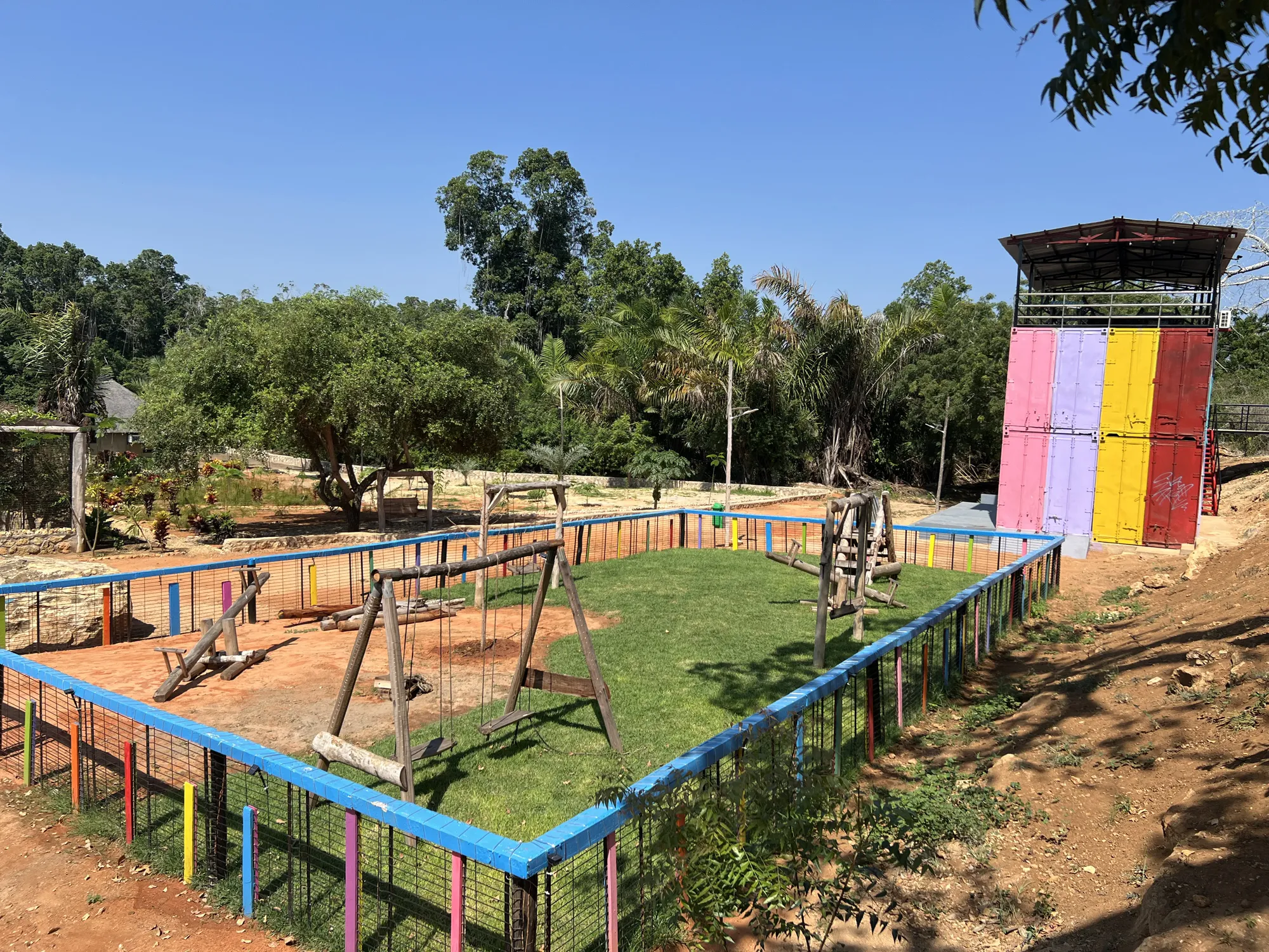 Children's playground with wooden swings and seesaws